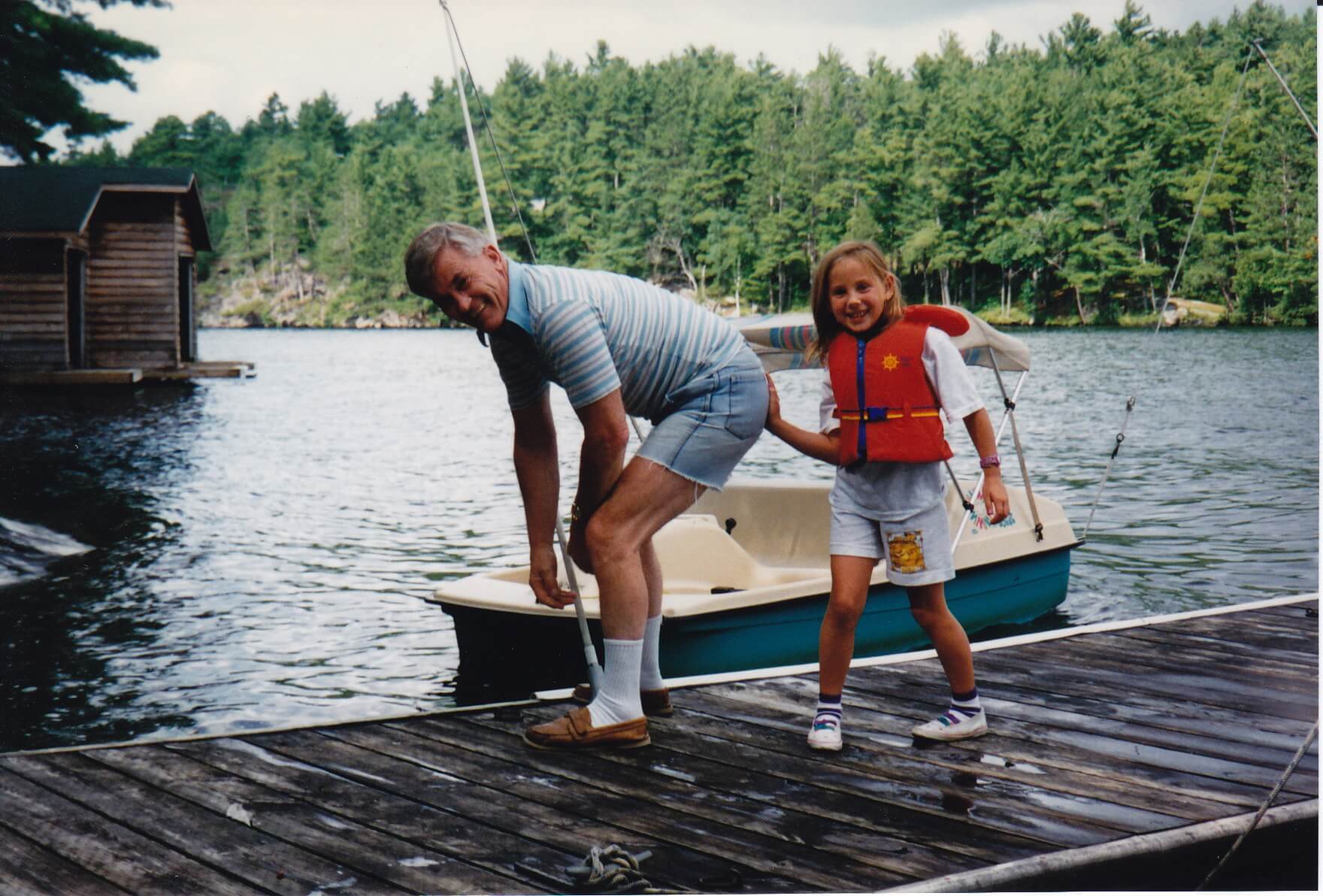 Young Mia with Papa on a lakeside dock